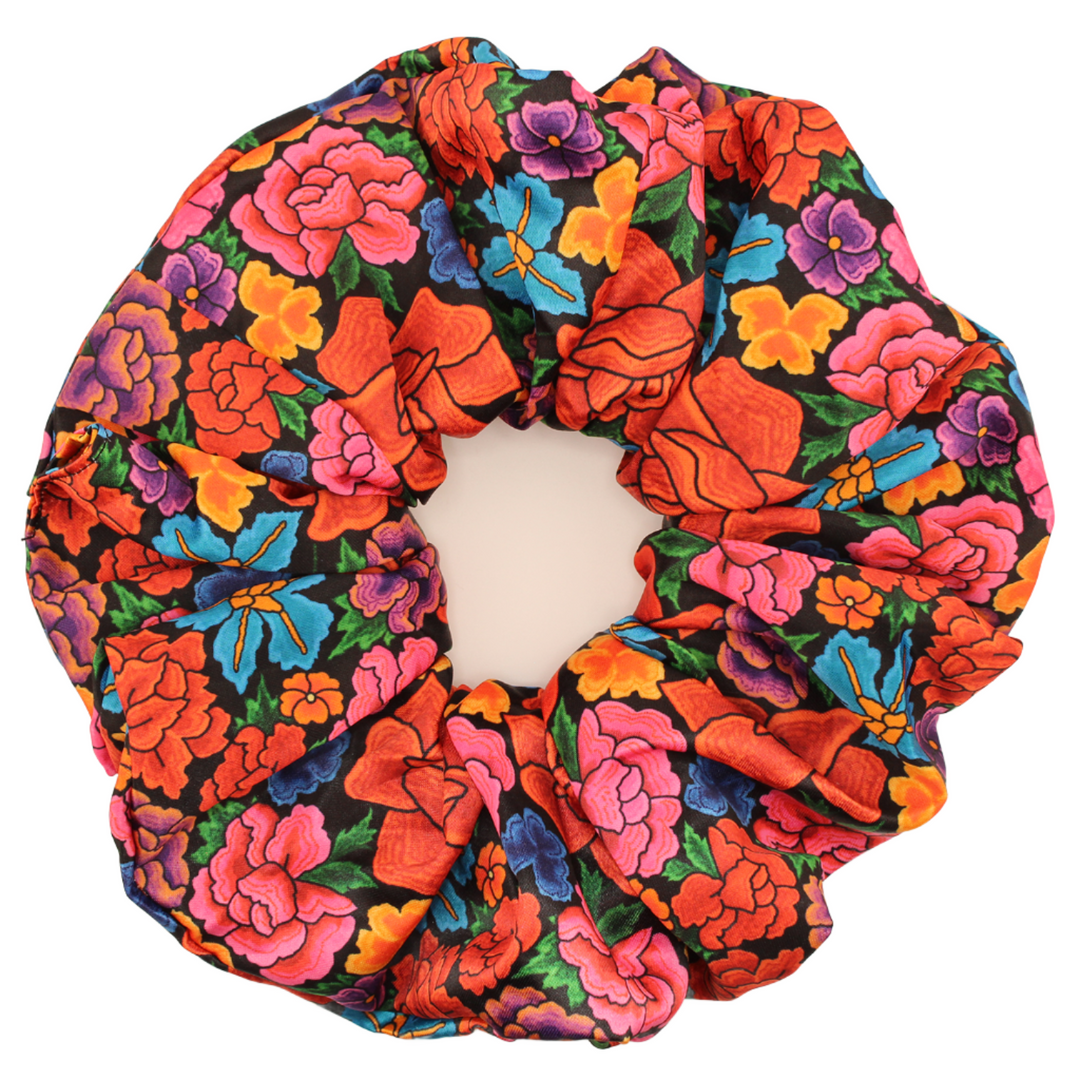 Bring a fiesta to your hair with our scrunchies, showcasing vibrant traditional Mexican patterns! Find the one that perfectly matches your personality. Each scrunchie features a unique custom print inspired by Tenangos, the exquisite embroidery style of the Otomi Culture. These designs are characterized by their colorful and imaginative patterns, featuring enchanting flowers and animals. Embrace the fantastical charm of Otomi artistry with every wear.